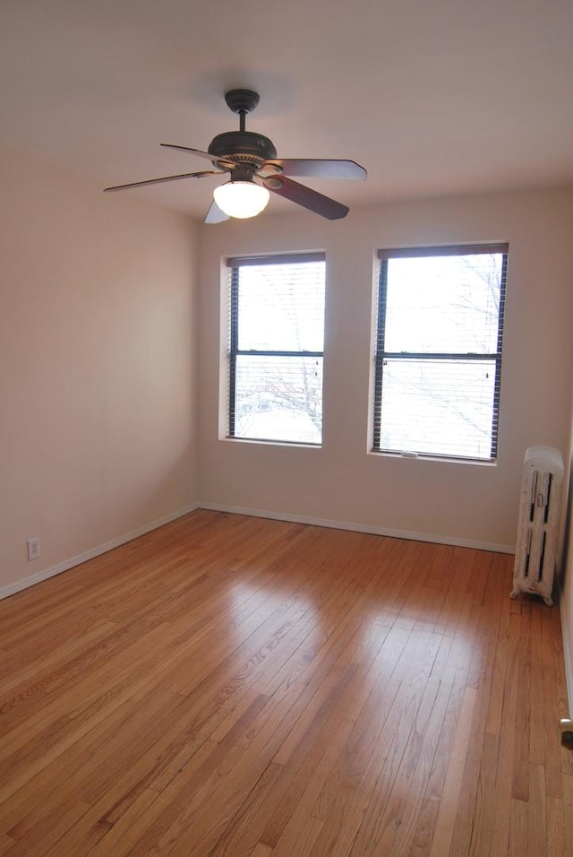 6207 N Winthrop Ave Unit 30, Chicago, IL 60660 - empty room with radiator, light wood-style flooring, and a ceiling fan