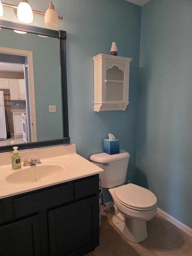 415 Andrea Ct, Harvard, IL 60033 - half bath with vanity, washer / clothes dryer, and tile patterned floors