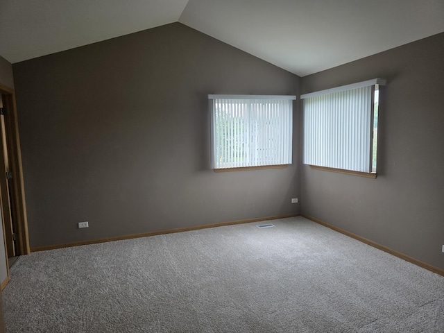 415 Andrea Ct, Harvard, IL 60033 - carpeted spare room with lofted ceiling and baseboards
