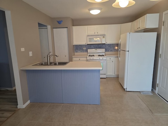 415 Andrea Ct, Harvard, IL 60033 - kitchen featuring white appliances, a peninsula, white cabinetry, light countertops, and light tile patterned floors