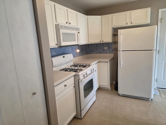 415 Andrea Ct, Harvard, IL 60033 - kitchen featuring white appliances, light countertops, light tile patterned floors, white cabinetry, and tasteful backsplash
