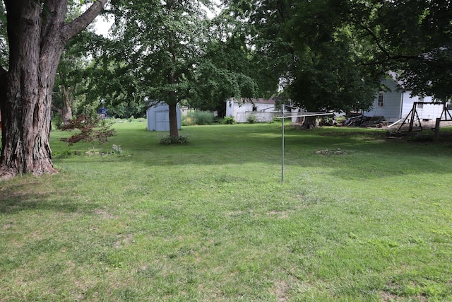 207 E N St, Walnut, IL 61376 - view of green lawn with a storage unit