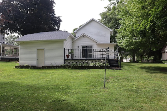 207 E N St, Walnut, IL 61376 - rear view of property with a wooden deck and a lawn