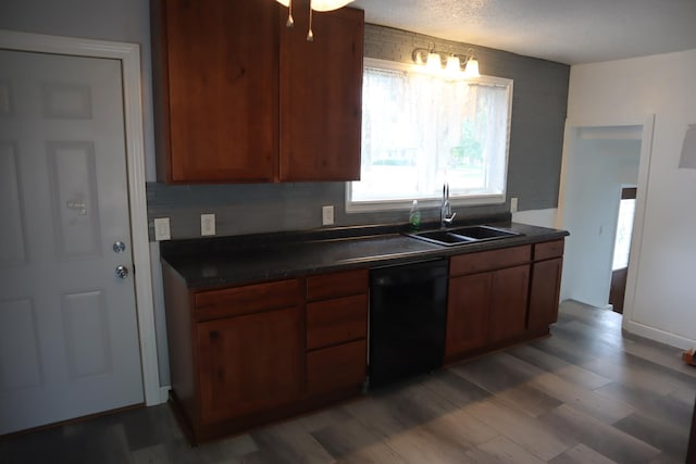 207 E N St, Walnut, IL 61376 - kitchen featuring black dishwasher, dark countertops, wood finished floors, and brown cabinetry