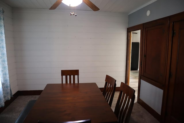 207 E N St, Walnut, IL 61376 - carpeted dining area featuring wooden walls, a ceiling fan, and wooden ceiling