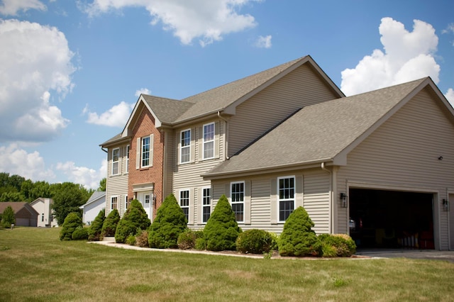 2952 Blue Oats Dr, Rockford, IL 61102 - view of front of home with a garage, a front yard, a shingled roof, and driveway