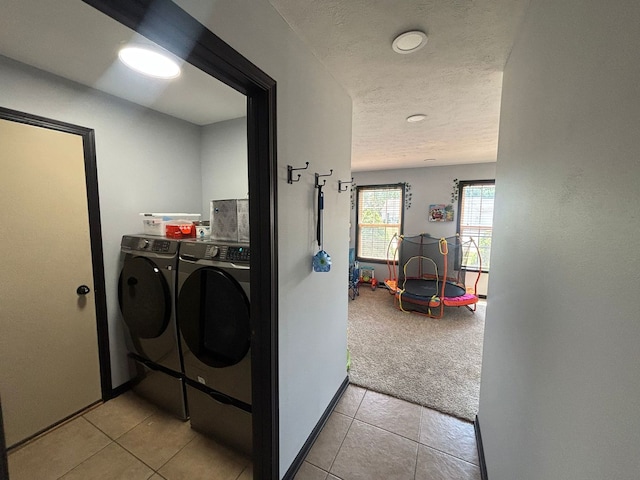 2952 Blue Oats Dr, Rockford, IL 61102 - washroom featuring separate washer and dryer, light carpet, light tile patterned floors, and a textured ceiling