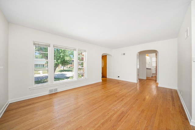 5145 Lee St, Skokie, IL 60077 - unfurnished room with arched walkways and light wood-style floors