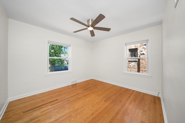 5145 Lee St, Skokie, IL 60077 - empty room with light wood-style floors and a ceiling fan