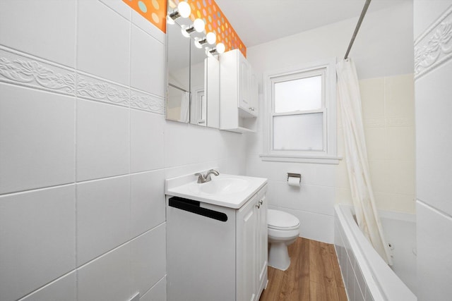 5145 Lee St, Skokie, IL 60077 - full bath featuring wood finished floors, vanity, shower / tub combo with curtain, and tile walls