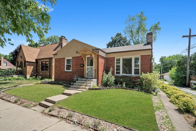5145 Lee St, Skokie, IL 60077 - view of front facade with a chimney, brick siding, and a front lawn