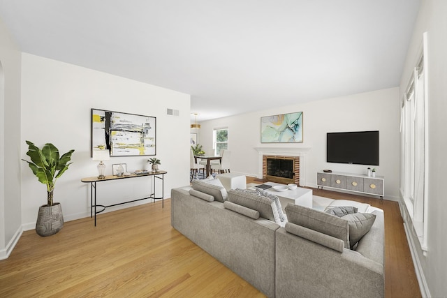 5145 Lee St, Skokie, IL 60077 - living room with light wood-style floors and a brick fireplace