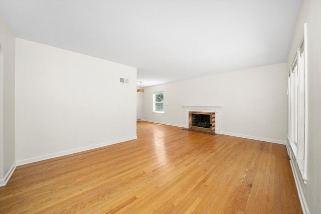 5145 Lee St, Skokie, IL 60077 - unfurnished living room featuring light wood-type flooring and a fireplace