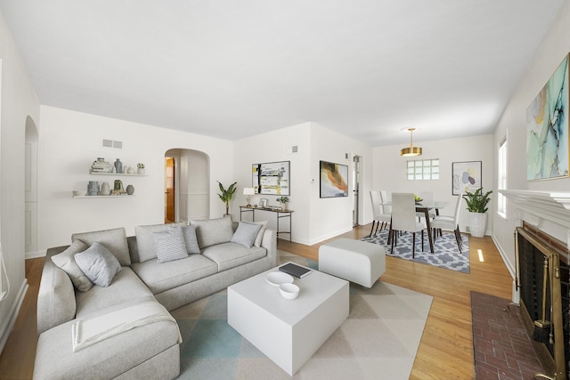 5145 Lee St, Skokie, IL 60077 - living area with arched walkways and light wood finished floors