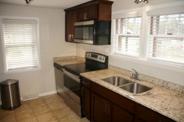 3325 Gilead Ave, Zion, IL 60099 - kitchen featuring stainless steel range with electric stovetop, black microwave, light tile patterned floors, light stone countertops, and dark brown cabinets