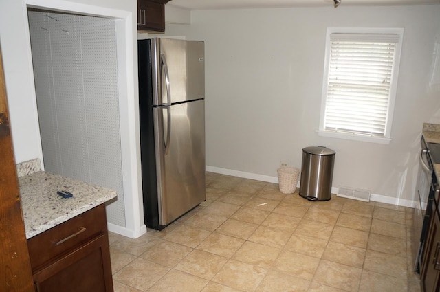 3325 Gilead Ave, Zion, IL 60099 - kitchen featuring freestanding refrigerator, dark brown cabinets, and light stone counters