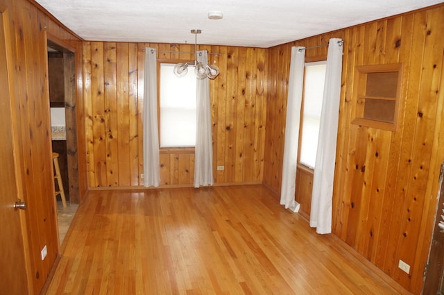 3325 Gilead Ave, Zion, IL 60099 - unfurnished dining area with wood finished floors, a chandelier, and wooden walls