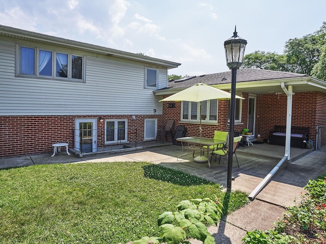 913 S See Gwun Ave, Mount Prospect, IL 60056 - back of house featuring brick siding, a yard, and a patio area