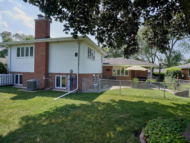 913 S See Gwun Ave, Mount Prospect, IL 60056 - back of property with a chimney, a fenced backyard, and brick siding