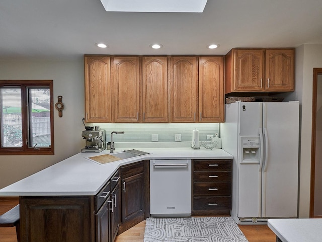 913 S See Gwun Ave, Mount Prospect, IL 60056 - kitchen with white appliances, light countertops, recessed lighting, decorative backsplash, and a peninsula