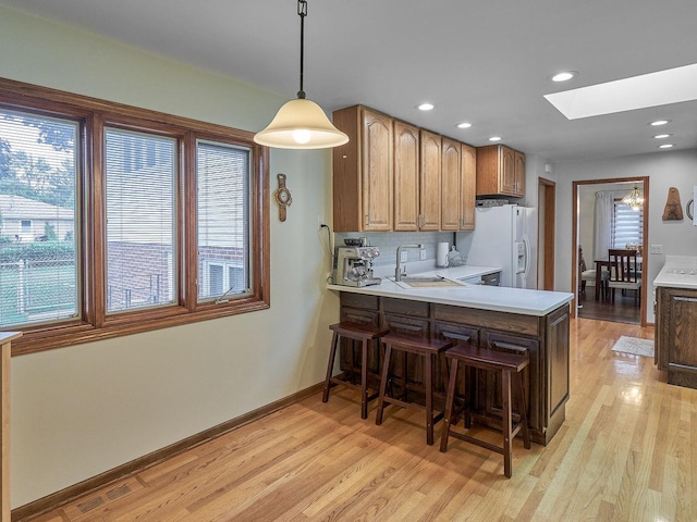 913 S See Gwun Ave, Mount Prospect, IL 60056 - kitchen with white refrigerator with ice dispenser, a skylight, plenty of natural light, light countertops, and recessed lighting