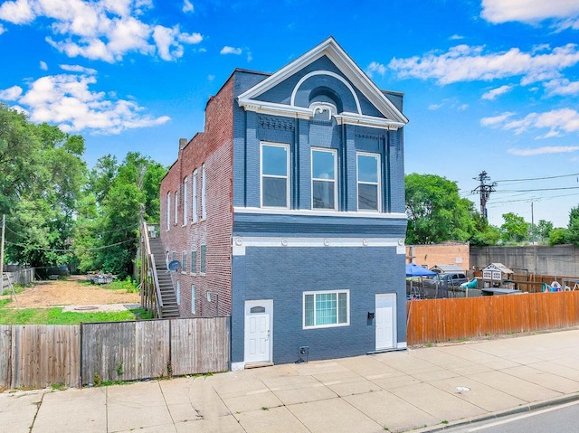 396 E Kensington Ave, Chicago, IL 60628 - view of front of home featuring brick siding, a fenced backyard, and a patio area