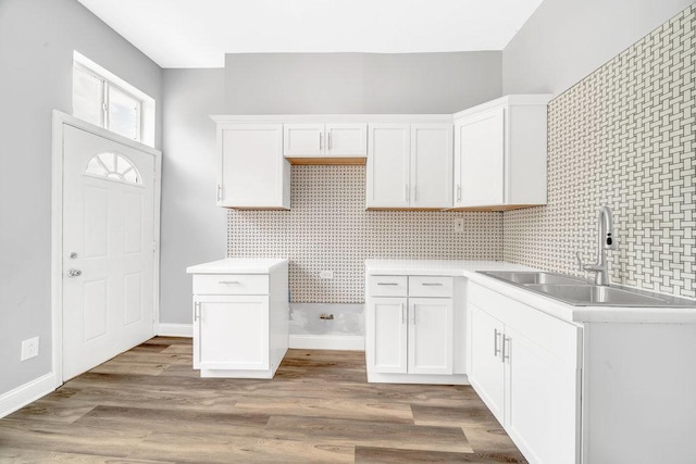 396 E Kensington Ave, Chicago, IL 60628 - kitchen featuring white cabinetry, light wood-type flooring, and light countertops