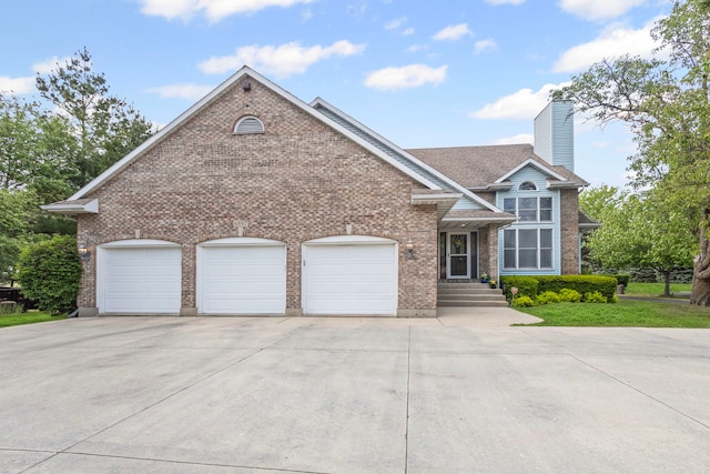 6897 Galena Rd, Bristol, IL 60512 - view of front of property with driveway, an attached garage, brick siding, and a chimney