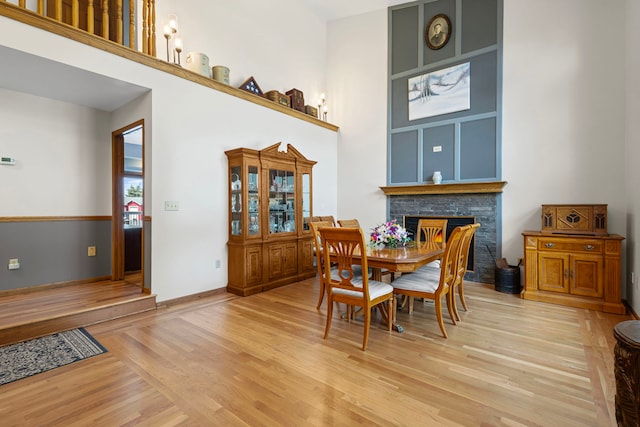 6897 Galena Rd, Bristol, IL 60512 - dining room with light wood finished floors, a fireplace, and a towering ceiling