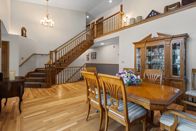 6897 Galena Rd, Bristol, IL 60512 - dining area with a chandelier, wood finished floors, a towering ceiling, stairs, and recessed lighting