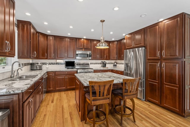6897 Galena Rd, Bristol, IL 60512 - kitchen featuring appliances with stainless steel finishes, light wood-style flooring, light stone countertops, tasteful backsplash, and recessed lighting