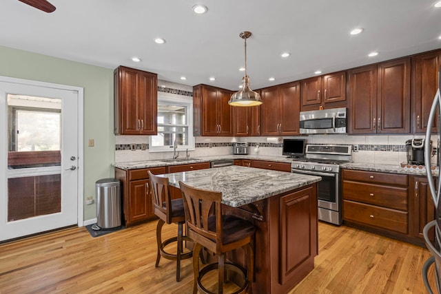 6897 Galena Rd, Bristol, IL 60512 - kitchen with stainless steel appliances, tasteful backsplash, light wood-type flooring, a center island, and recessed lighting