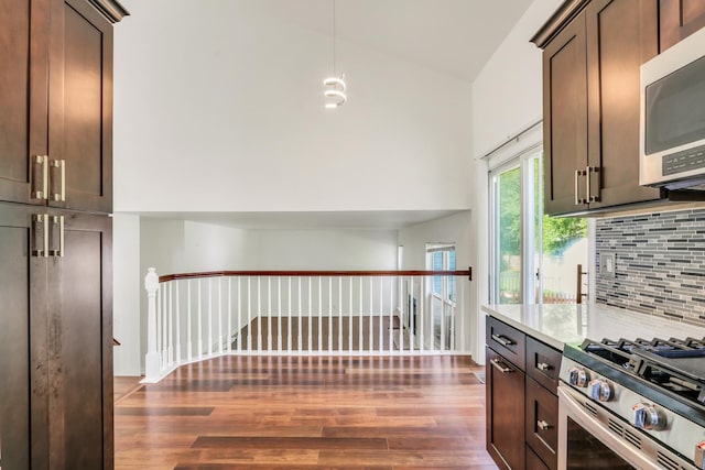 1379 Clavey Ln, Gurnee, IL 60031 - kitchen with appliances with stainless steel finishes, dark wood-type flooring, tasteful backsplash, dark brown cabinets, and a high ceiling