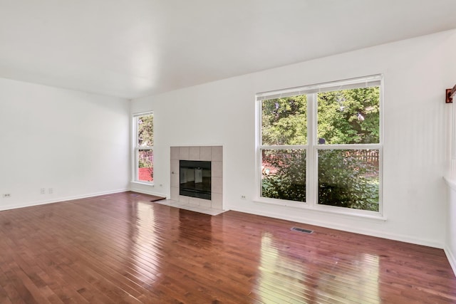 1379 Clavey Ln, Gurnee, IL 60031 - unfurnished living room featuring hardwood / wood-style floors and a tiled fireplace