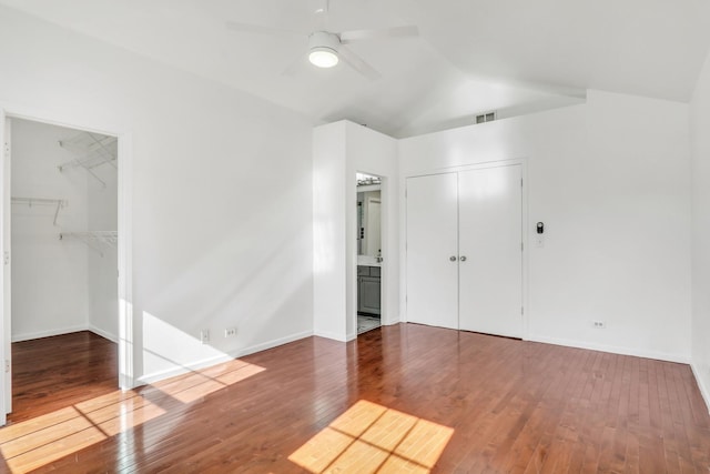 1379 Clavey Ln, Gurnee, IL 60031 - unfurnished bedroom with wood-type flooring, lofted ceiling, a spacious closet, and a ceiling fan