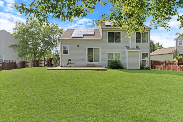 1379 Clavey Ln, Gurnee, IL 60031 - rear view of house featuring solar panels, a fenced backyard, and a shingled roof