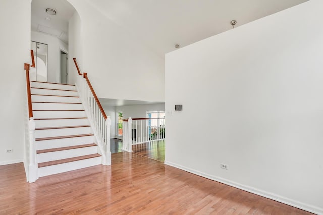 1379 Clavey Ln, Gurnee, IL 60031 - unfurnished living room featuring a high ceiling, wood finished floors, and stairs