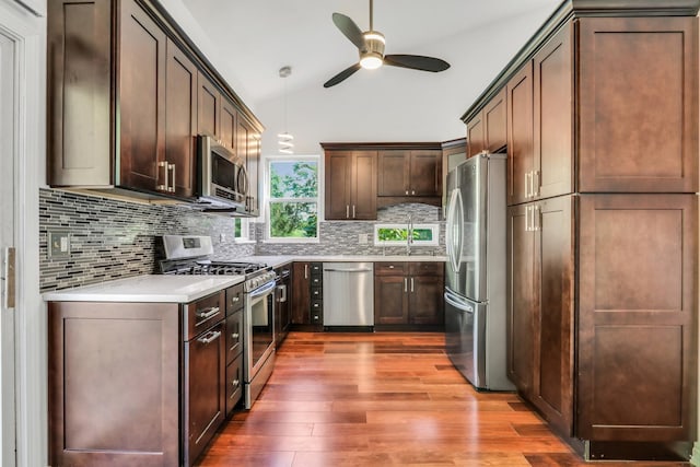 1379 Clavey Ln, Gurnee, IL 60031 - kitchen with stainless steel appliances, ceiling fan, wood finished floors, tasteful backsplash, and vaulted ceiling