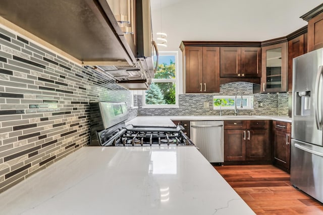 1379 Clavey Ln, Gurnee, IL 60031 - kitchen featuring stainless steel appliances, backsplash, dark wood-style flooring, and light stone countertops