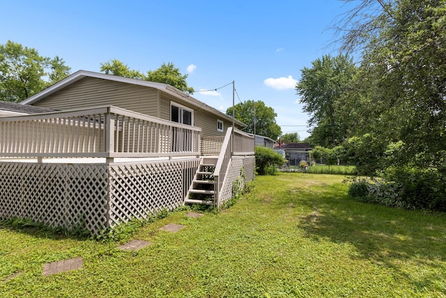 4809 Cayuga Rd, Rockford, IL 61107 - rear view of house with stairs, a lawn, and a wooden deck