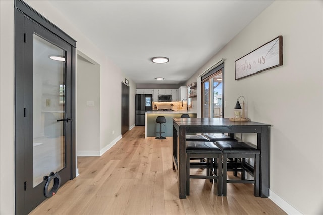 1617 Addleman St, Joliet, IL 60431 - dining area with light wood-type flooring and baseboards