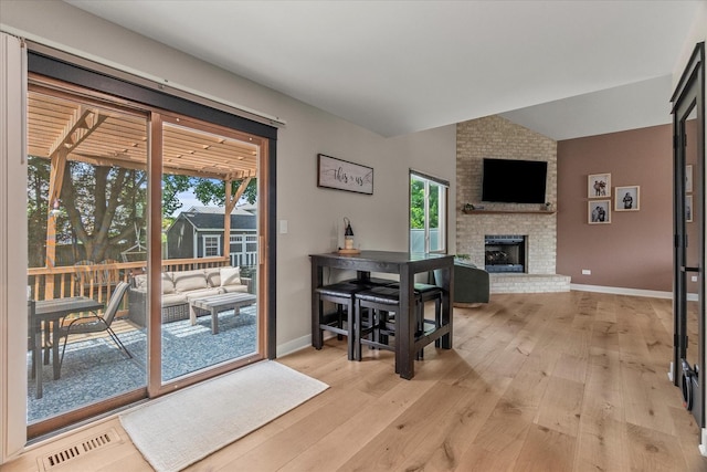 1617 Addleman St, Joliet, IL 60431 - dining area featuring lofted ceiling, light wood finished floors, and a brick fireplace