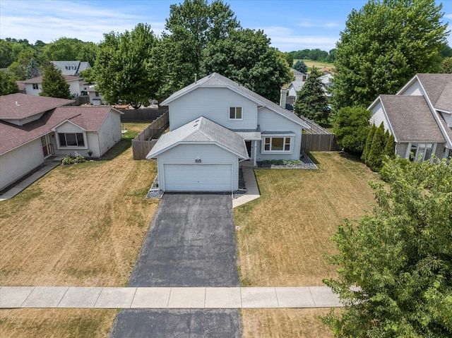 1617 Addleman St, Joliet, IL 60431 - traditional-style home featuring driveway, a residential view, a garage, and a chimney