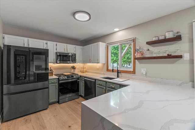 1617 Addleman St, Joliet, IL 60431 - kitchen featuring appliances with stainless steel finishes, light stone countertops, light wood-style flooring, white cabinetry, and open shelves