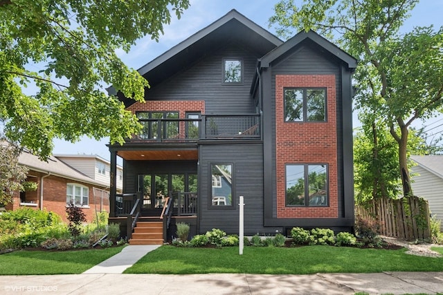 2715 Reese Ave, Evanston, IL 60201 - modern home with a balcony, a front lawn, covered porch, and brick siding