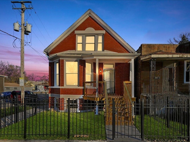 6501 S Hamilton Ave, Chicago, IL 60636 - view of front facade with a porch, brick siding, and a fenced front yard