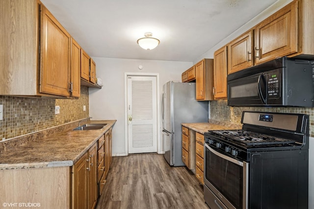 1340 Kingsbury Dr Unit 2, Hanover Park, IL 60133 - kitchen featuring stainless steel appliances, tasteful backsplash, dark wood-style floors, and brown cabinets