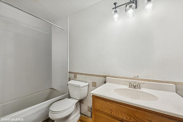 1340 Kingsbury Dr Unit 2, Hanover Park, IL 60133 - bathroom with vanity, bathtub / shower combination, tile walls, and wainscoting