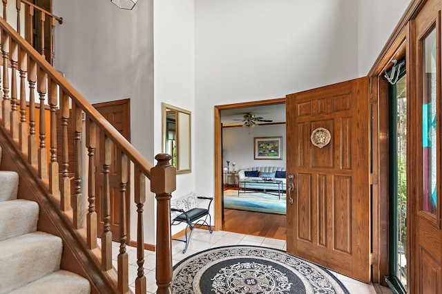 1606 Gregden Shores Dr, Sterling, IL 61081 - foyer entrance with plenty of natural light, a towering ceiling, stairs, light tile patterned flooring, and ceiling fan