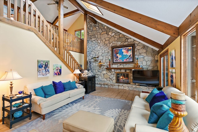 1606 Gregden Shores Dr, Sterling, IL 61081 - living room with beamed ceiling, a stone fireplace, a skylight, a ceiling fan, and stairs